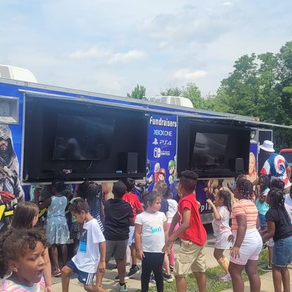 Party Game Truck at live event — kids lined up and playing