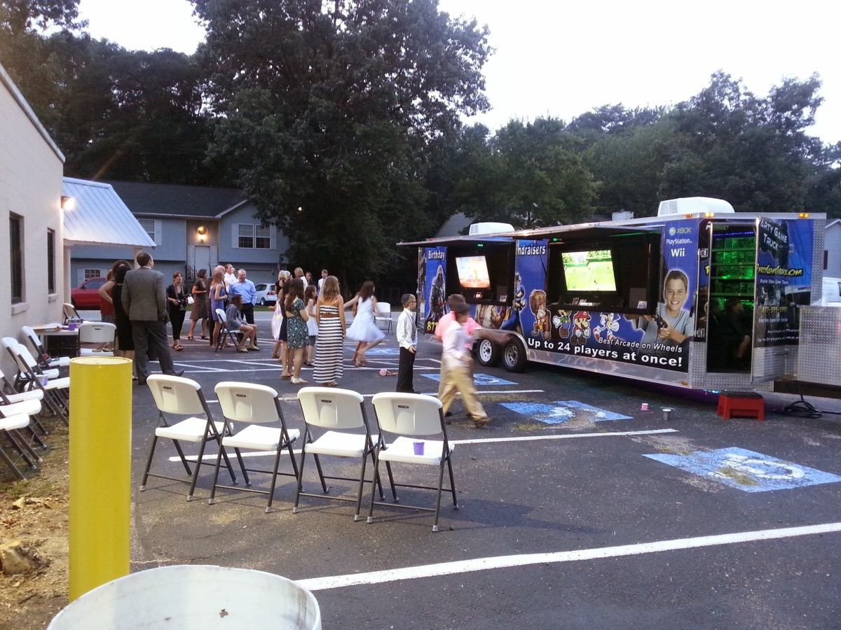 Party Game Truck at evening outdoor event with crowd