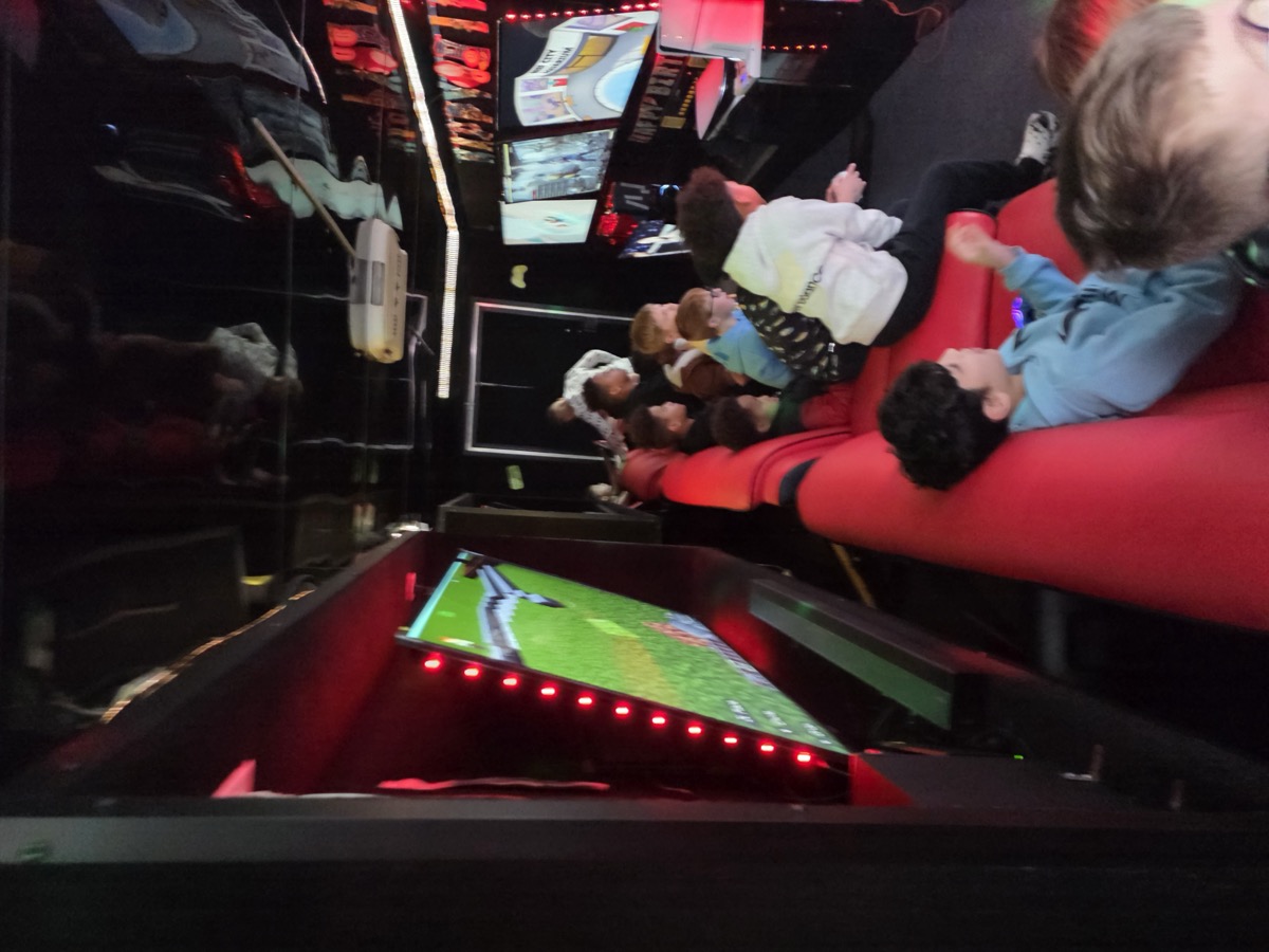 Kids gaming inside truck with red LED lights
