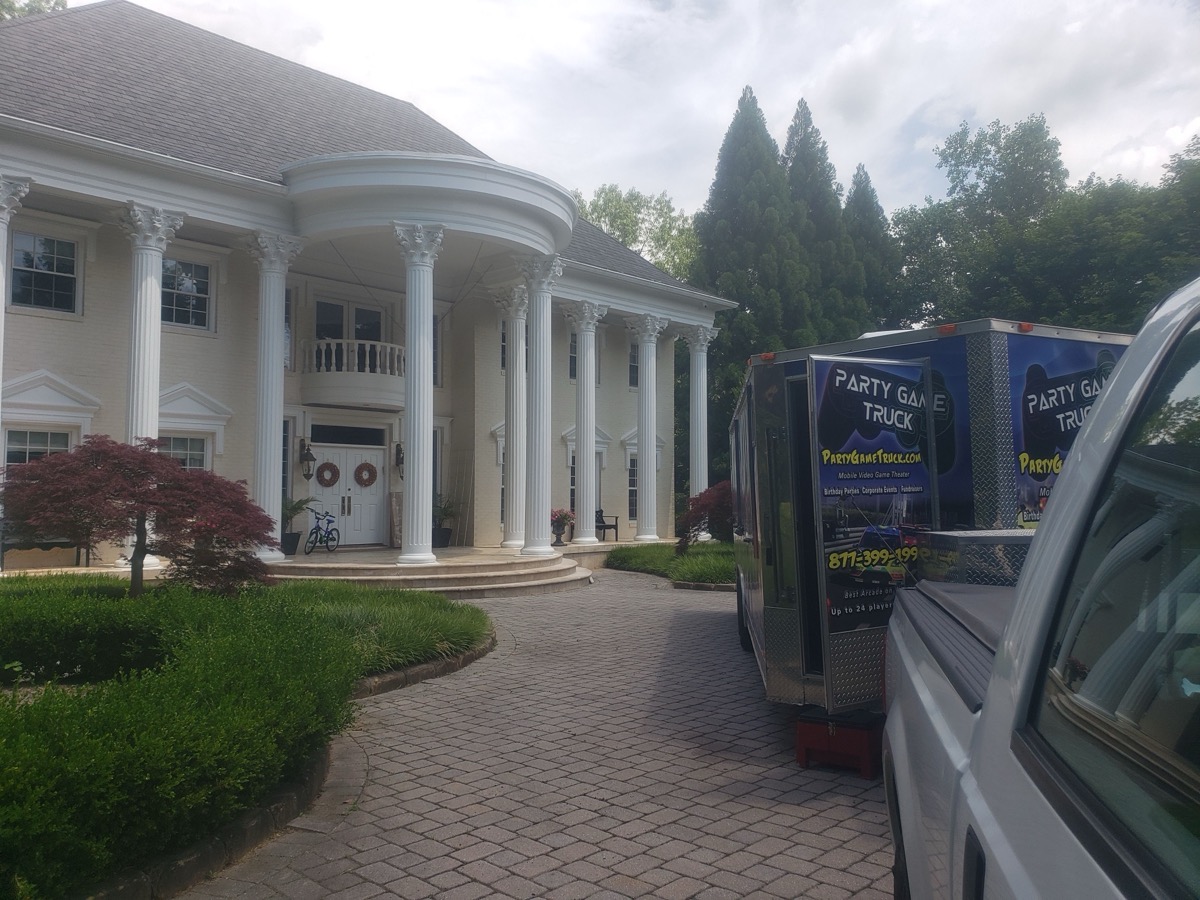 Party Game Truck parked at a luxury white mansion