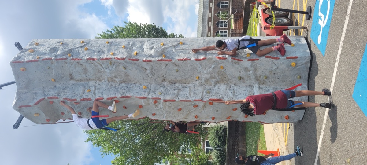 Kids climbing the rock wall at Party Game Truck event